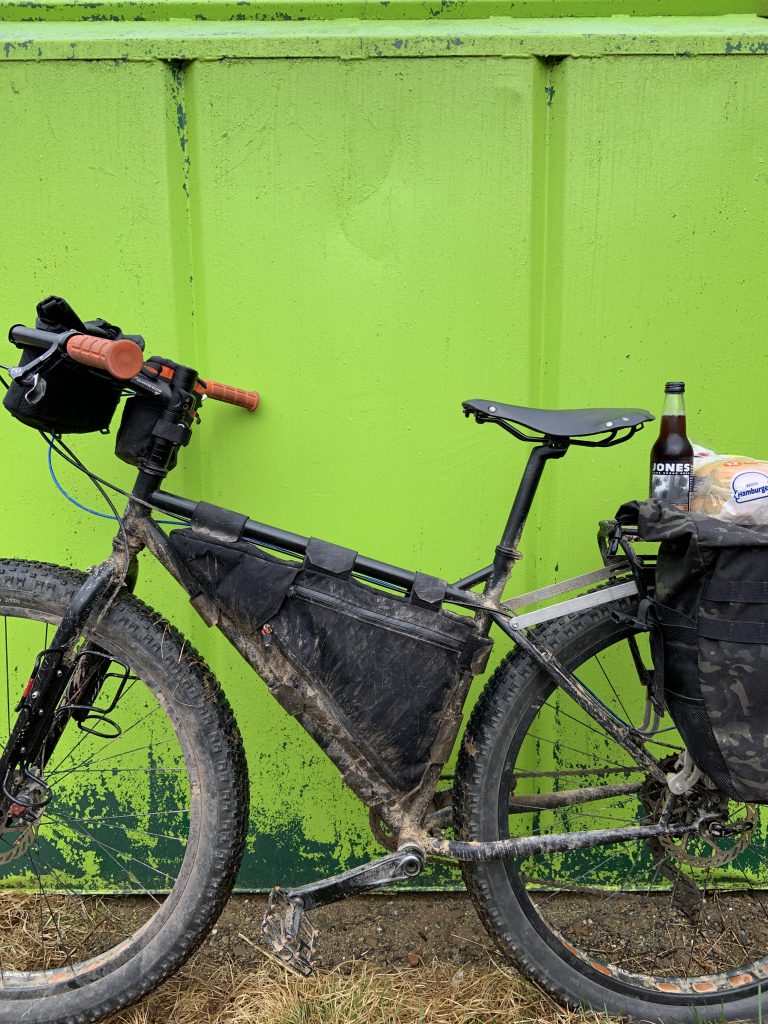 Surly pugsley against a dumpster.